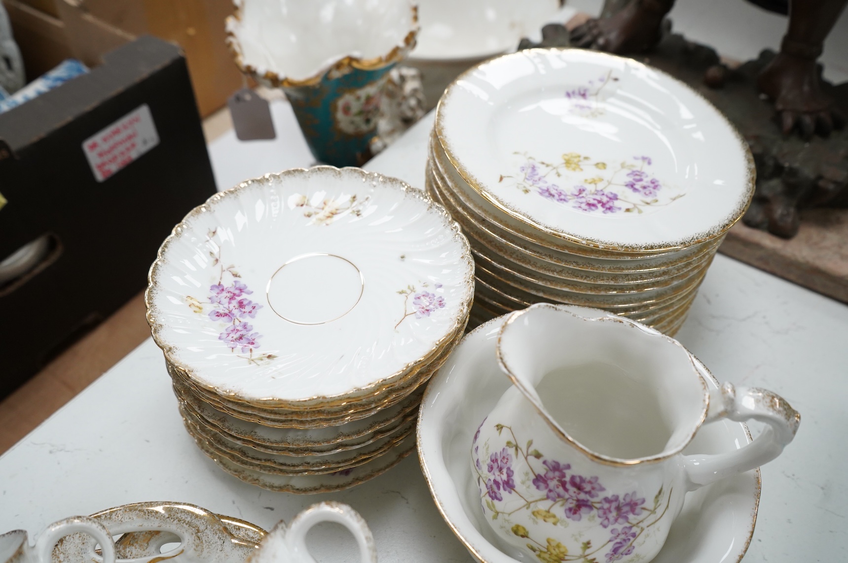 A KPM style floral porcelain part tea service, largest 27cm in diameter